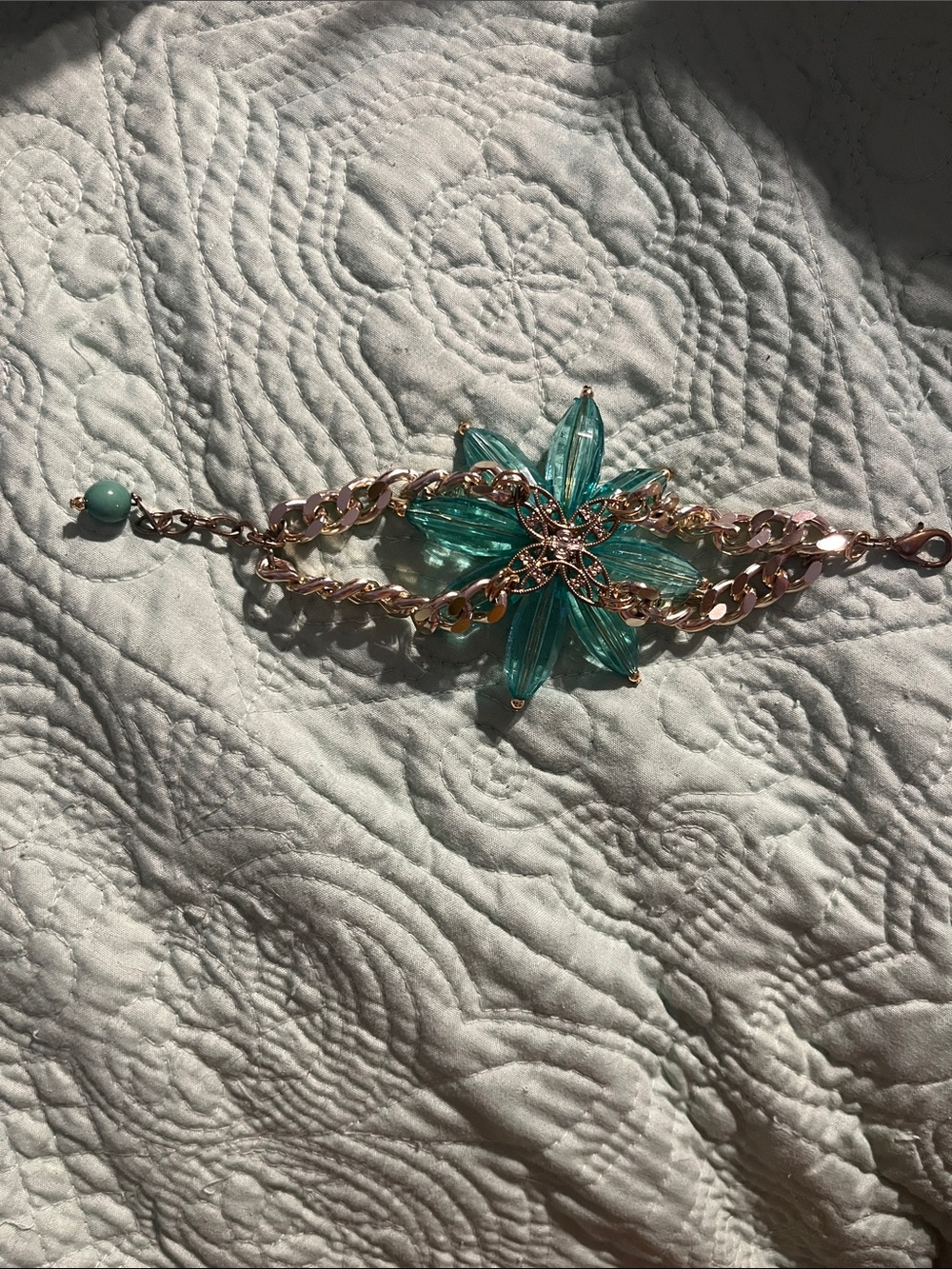 Gold color chained bracelet with green beads and porcelain flower